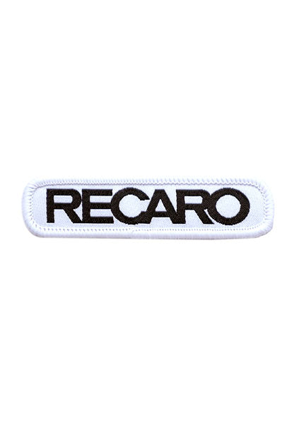 Der Patch RECARO 70x15mm von RECARO ist ein rechteckiger weißer Patch mit abgerundeten Ecken, fettem schwarzen RECARO-Schriftzug in Großbuchstaben, hochwertigem Material und weißen genähten Rändern für einen Premium-Look.