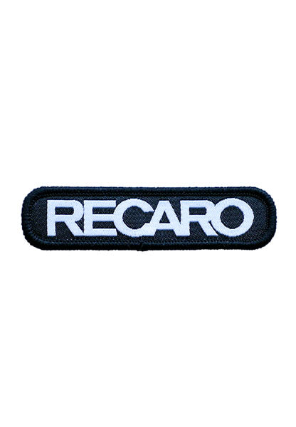 Der Patch RECARO 70x15mm von RECARO ist ein schwarzer rechteckiger Patch mit abgerundeten Kanten, hergestellt aus hochwertigem Material und zeigt in der Mitte „RECARO“ in fetten, weißen Großbuchstaben gestickt.