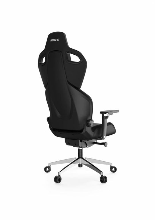 Der RECARO Shop RECARO Exo Platinum ist ein moderner schwarzer ergonomischer Bürostuhl mit hoher Rückenlehne, konturierter Copolymerform, verstellbaren Armlehnen auf Spezialrollen und einem fünfrädrigen Metallfuß, von hinten auf weißem Hintergrund abgebildet.