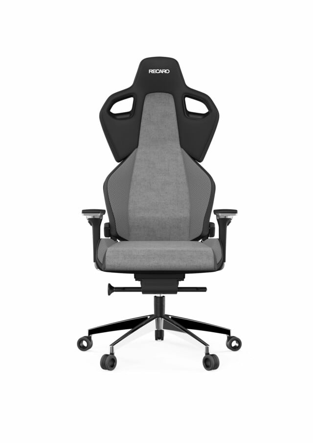 Der RECARO Exo Platinum aus dem RECARO Shop ist ein moderner ergonomischer Bürostuhl mit hoher Rückenlehne, grauem, atmungsaktivem Stoff, schwarzen Armlehnen, speziellen Rollen auf einem Fünfrad-Untergestell und zwei Aussparungen in der Nähe der Kopfstütze mit RECARO-Logo.