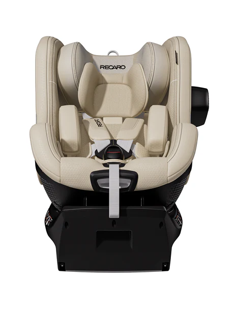 Der beige TORON 1 Kindersitz von RECARO Shop mit schwarzem Sockel, ergonomischer Form, 360°-Drehfunktion, Fünfpunktgurt, Kopfstütze und gepolsterten Seiten ist frontal auf weißem Hintergrund zu sehen.