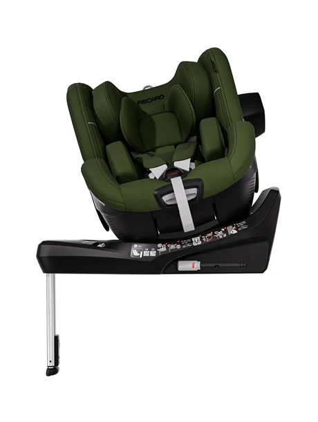 Der RECARO Shop TORON 1 ist ein grün-schwarzer Kindersitz mit ergonomischer Form, Liegefläche, 360°-Drehung, Stützfuß, Sicherheitsgurten und beschrifteter Anleitung an der Basis.
