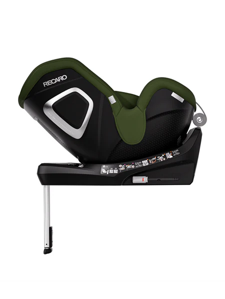 Der RECARO Shop TORON 1 Kindersitz in den Farben Schwarz und Grün ist auf einer schwarzen Basis mit Sicherheitsetiketten, ergonomischer Form, verstellbarem Stützfuß und 360°-Drehung für leichten Zugang dargestellt.