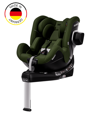 Ein dunkelgrüner und schwarzer TORON 1 KID-Kindersitz von RECARO Shop mit Sicherheitsgurt und Stützfuß, schräg abgebildet. Dieser sichere Kindersitz verfügt über eine 360°-Drehfunktion für einfachen Einstieg und einfache Einstellung und ist zudem mit einem runden „Made in Germany“-Emblem mit der deutschen Flagge in der oberen linken Ecke versehen.