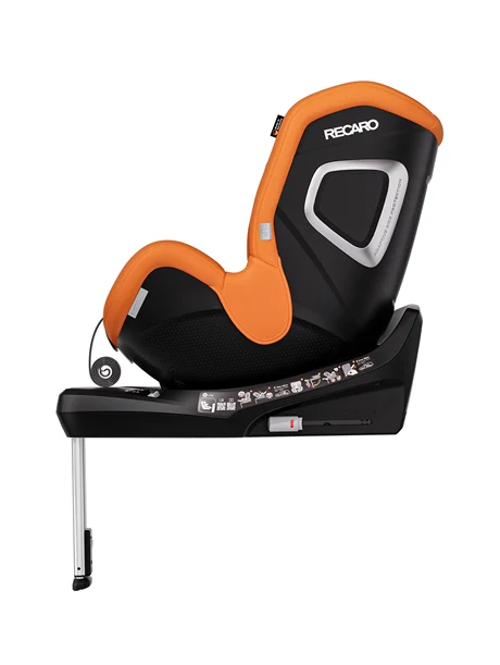 Eine Seitenansicht des RECARO Shop TORON 1 KID in Orange und Schwarz mit Stützfuß, Sicherheitsaufklebern auf dem Sockel und einer praktischen 360°-Drehfunktion, abgebildet vor einem schlichten weißen Hintergrund.